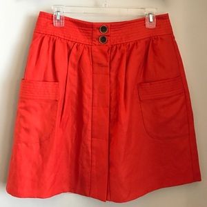 Blood Orange with tortoise button skirt