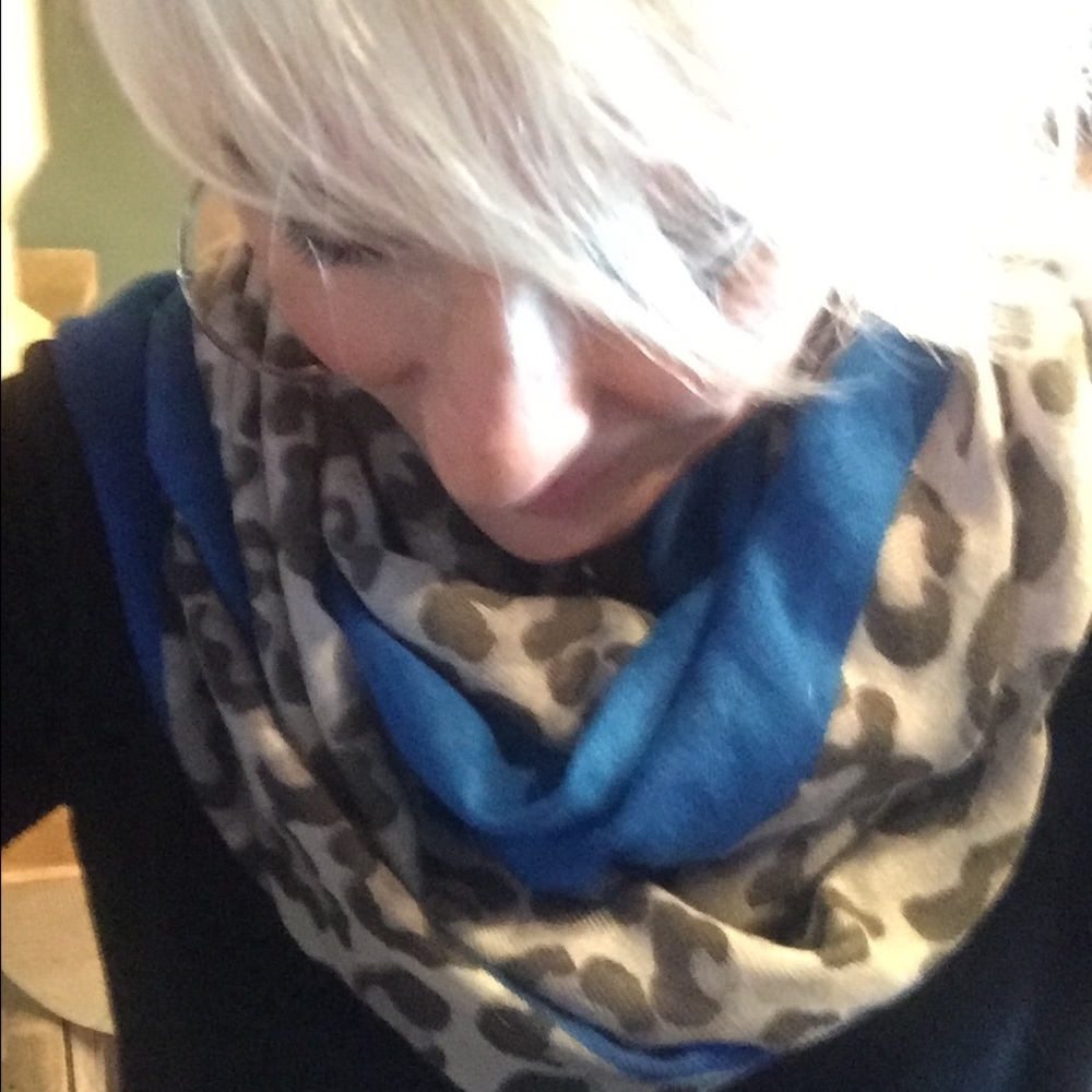 A animal print scarf with royal blue trim.