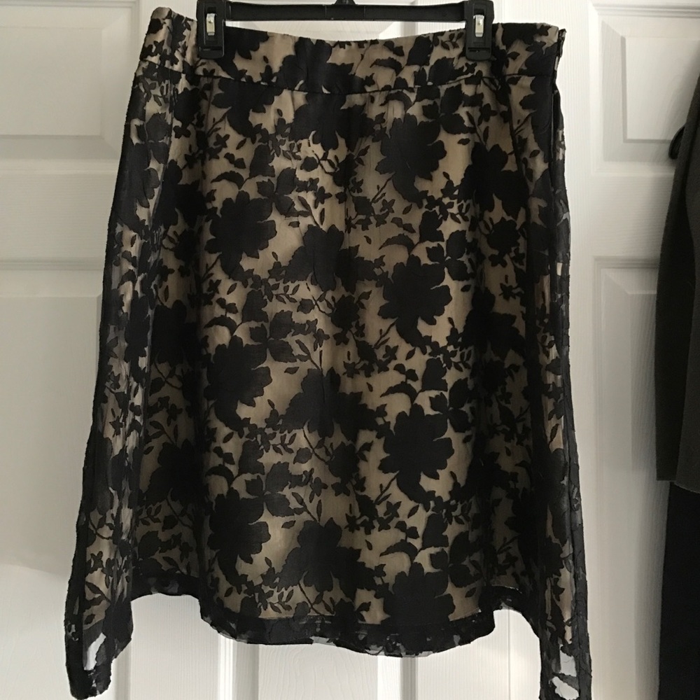 Metallic gold skirt with black shear overlay .