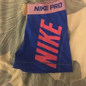 Blue and pink Nike pros
