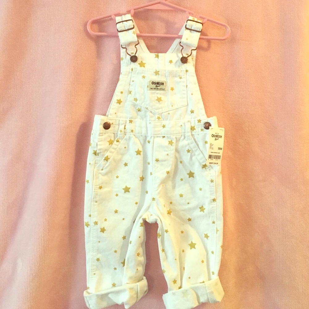 Baby girl white overalls with gold stars.
