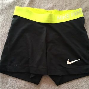 Black Nike pros with a yellow band