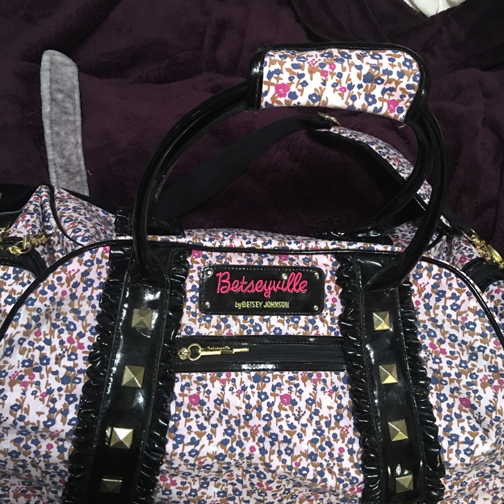 Betsy Johnson carry on/rolling case suitcase