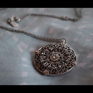 Silver necklace with silver, jeweled pendent