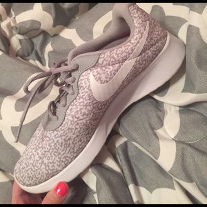 Gray & white NIke tennis shoes.