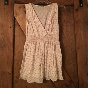 White sleeveless blouse with red polka dots