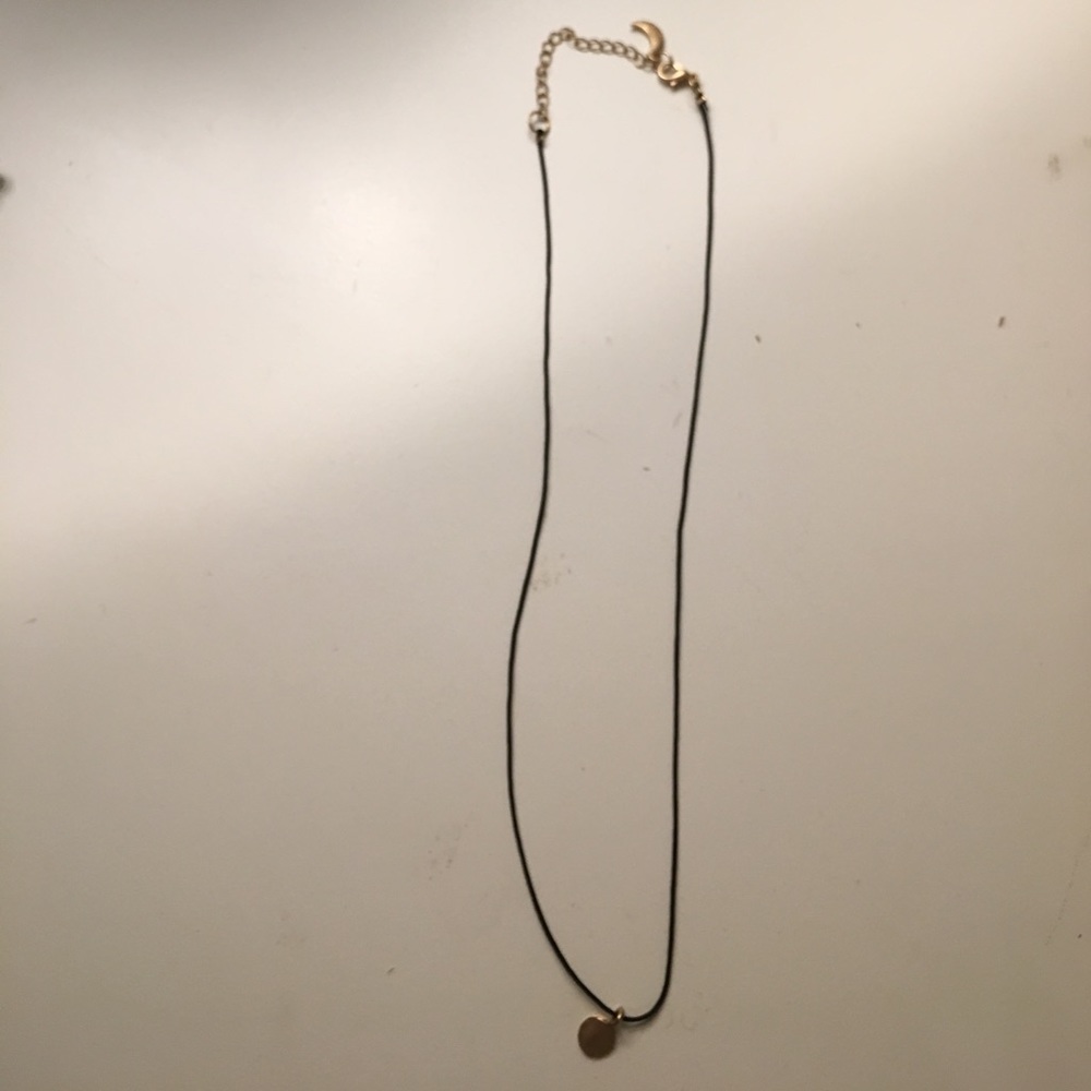 Black necklace with gold charm
