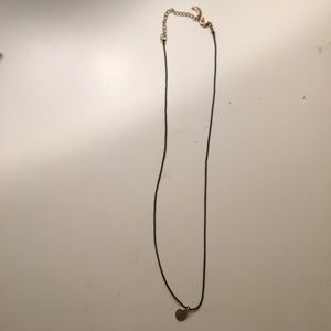 Black necklace with gold charm