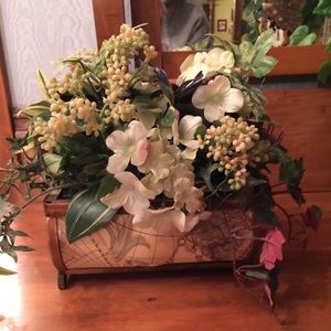 Unique flower Arrangement sits in a little case.
