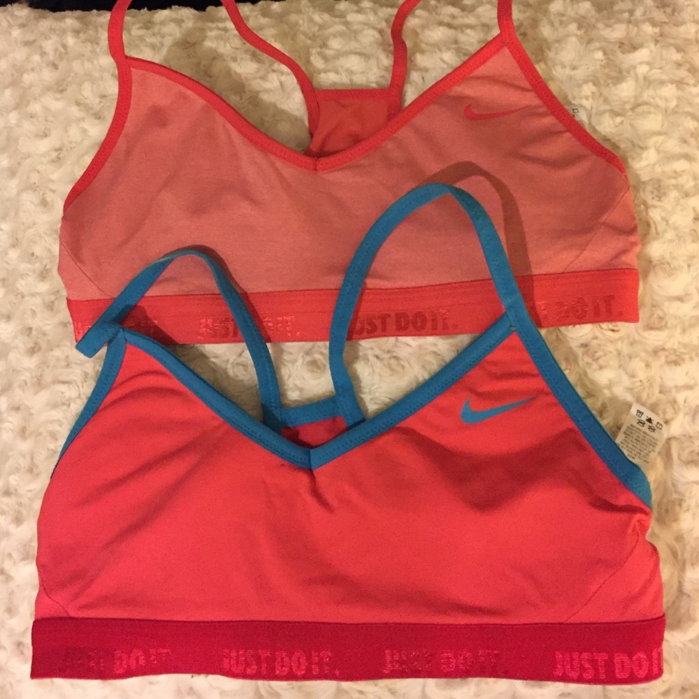 Two pink Nike sports bras