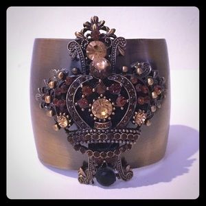 A cross and crown cuff bracelet