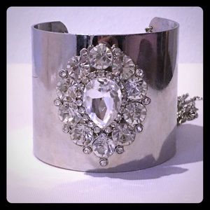 A cuff bracelet with chain tassels