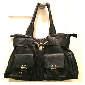 Black leather tote with large tassel on front.