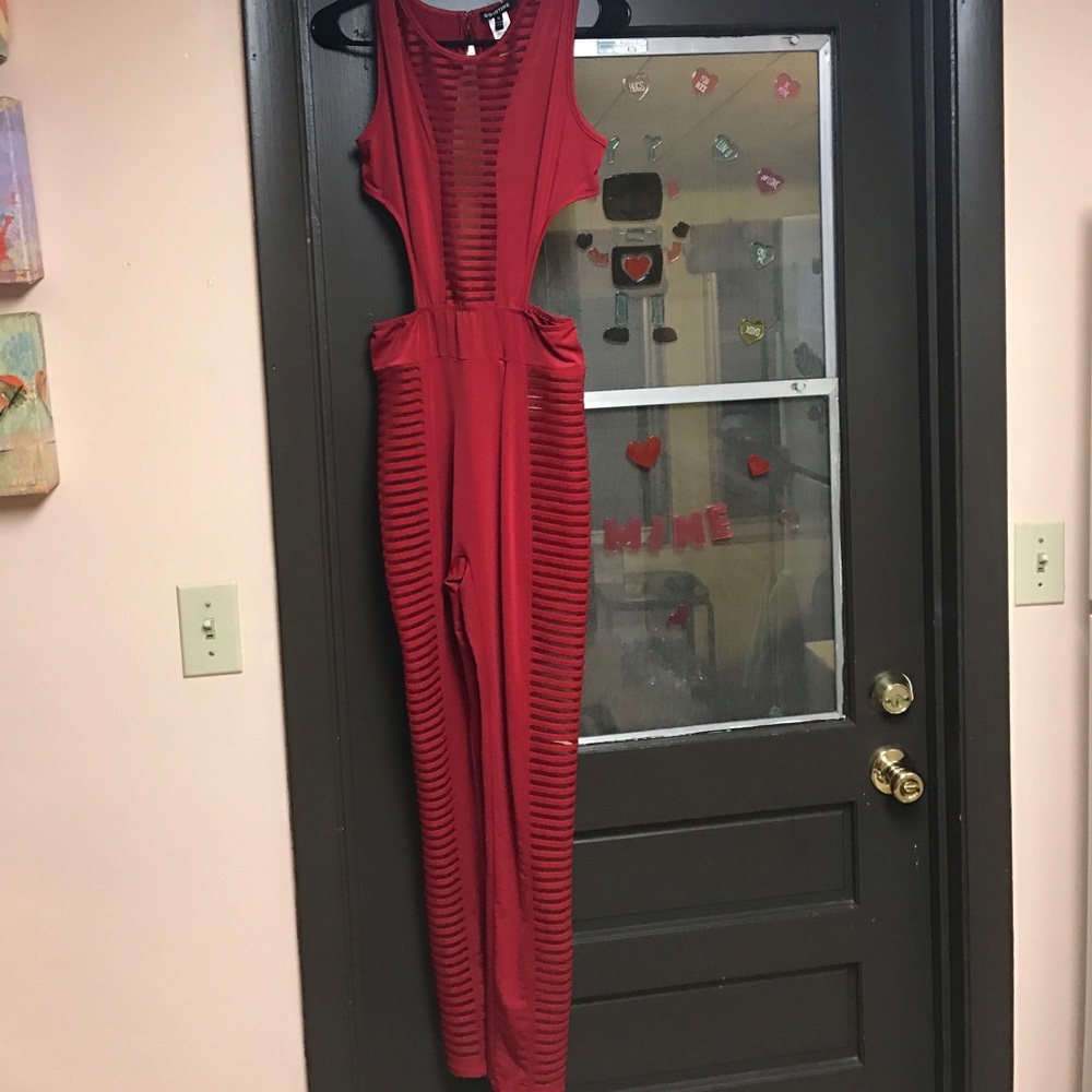 Red jumpsuit, 90% polyester, 10% elastane.