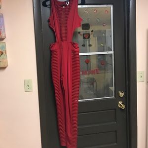 Red jumpsuit, 90% polyester, 10% elastane.