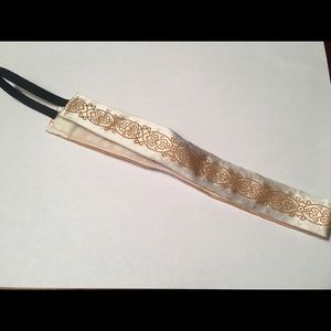 White &a gold NEVER WORN Sweaty Band headband