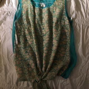 Blue blouse, flower design on front, cut in back