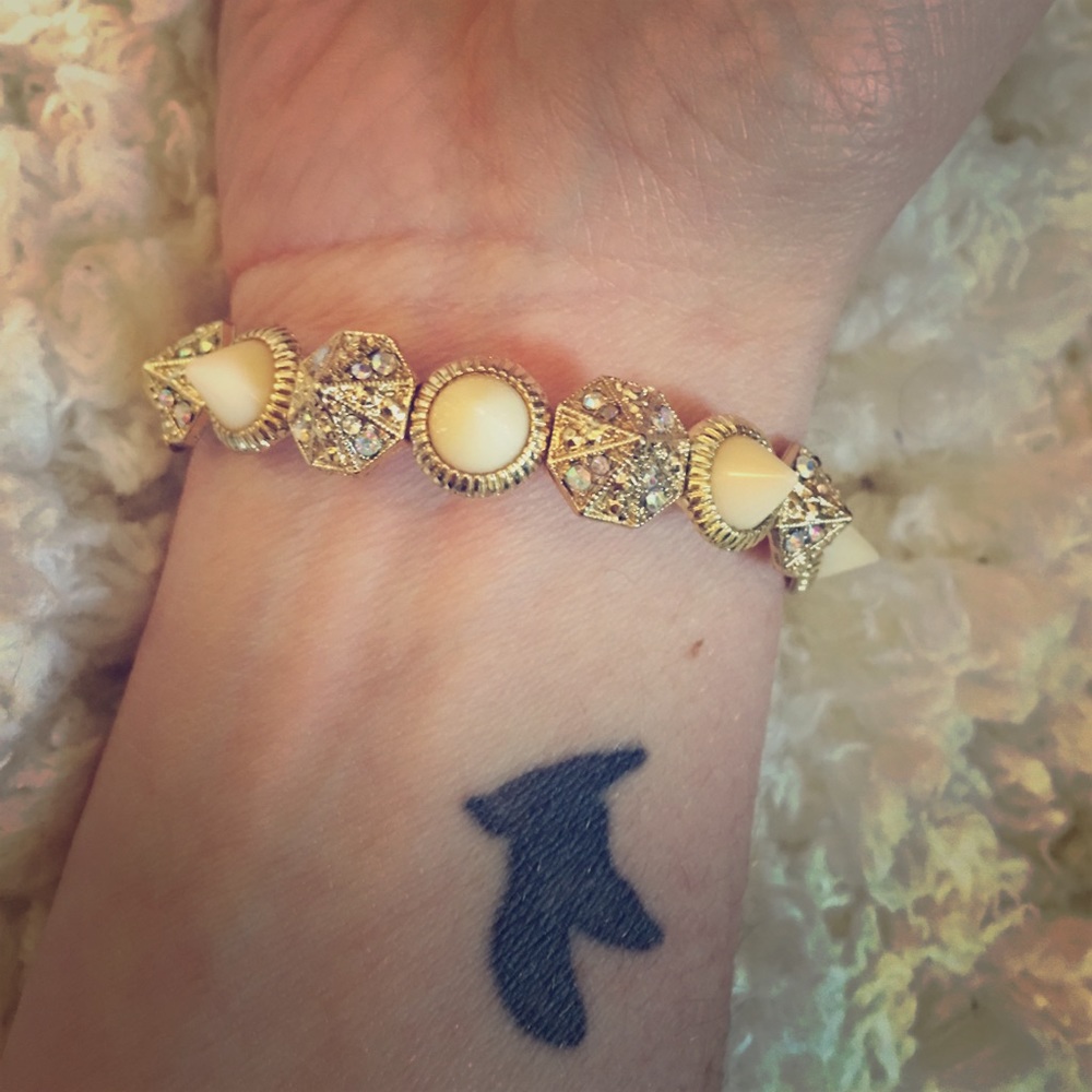 Gold and white spike bracelet.