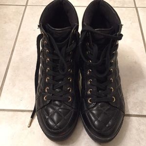 High top black sneakers.