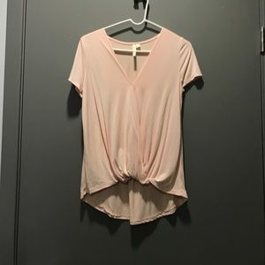 Light/neutral pink shirt sleeve blouse.