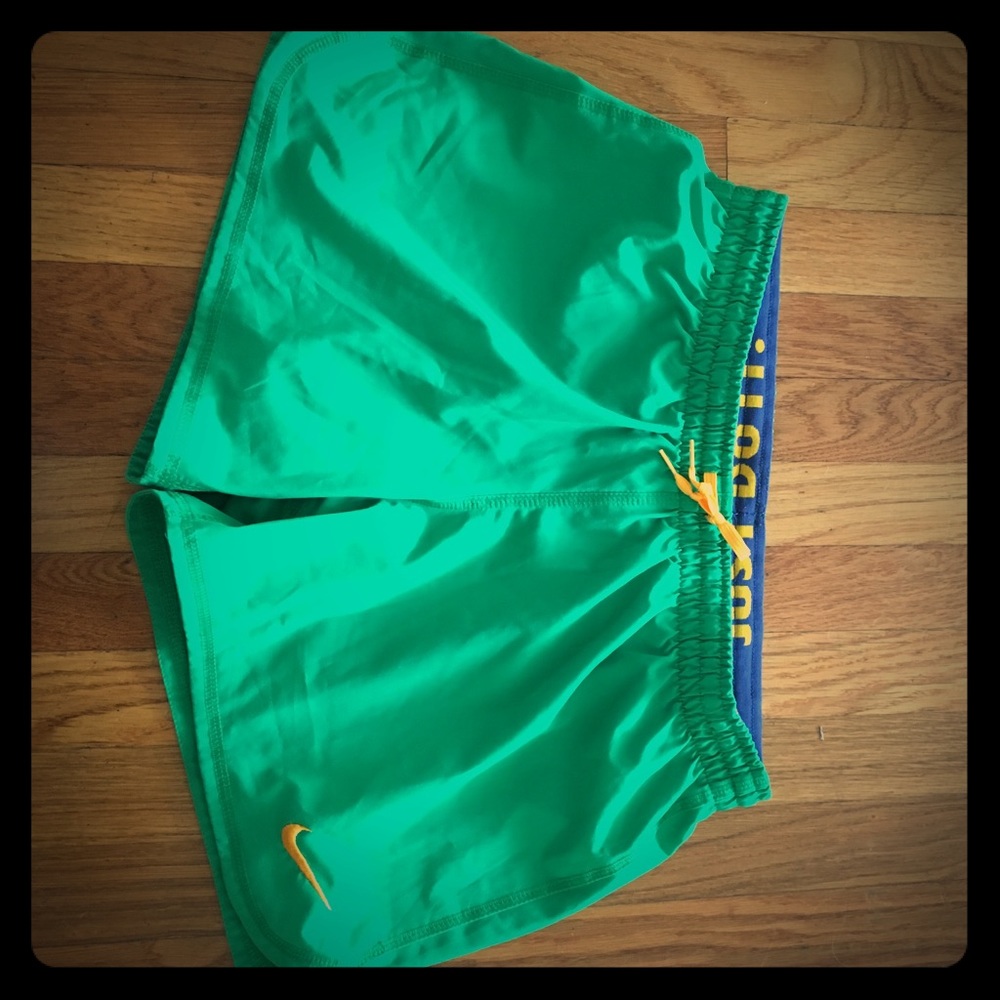 Size small green and yellow Nike running shorts.