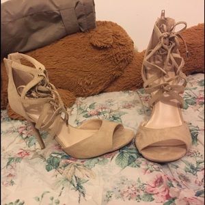 Beige leather open toe ankle strap high heels.