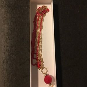 Chain necklace with round ornament.