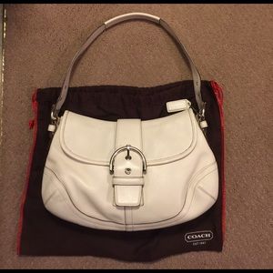 Coach leather shoulder handbag with dust cover.