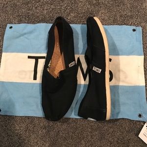 black toms with bag