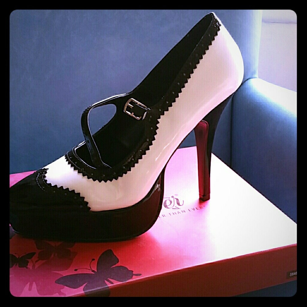 Black and white Pleaser saddle high heel shoes
