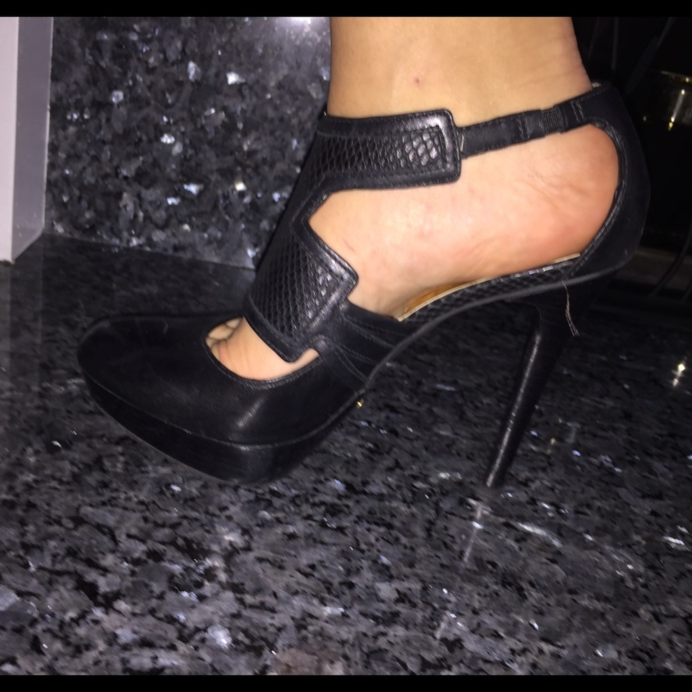 Oval-toed black leather platform heels