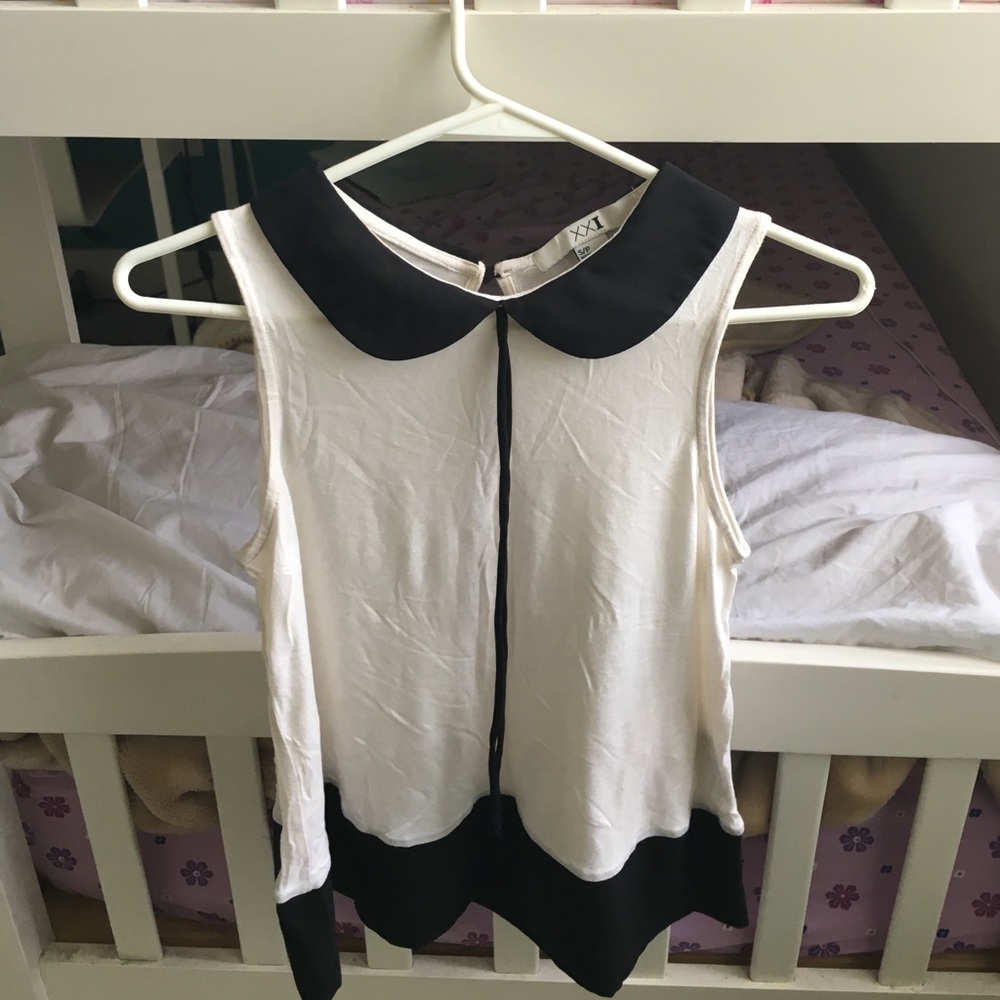 Beige top with black collar.