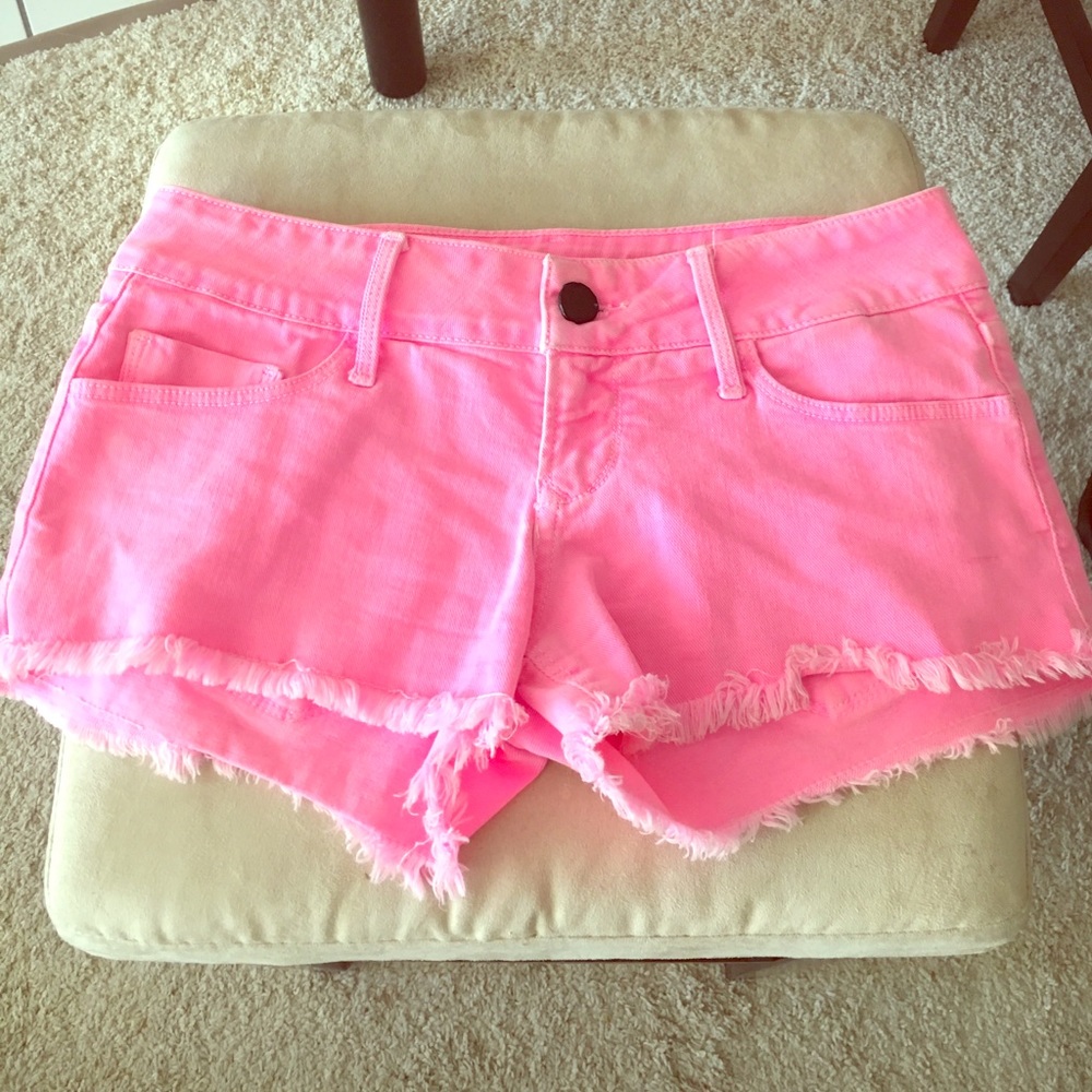 Pink cut off shorts.