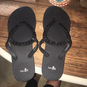 Black Sanuk flip flops
