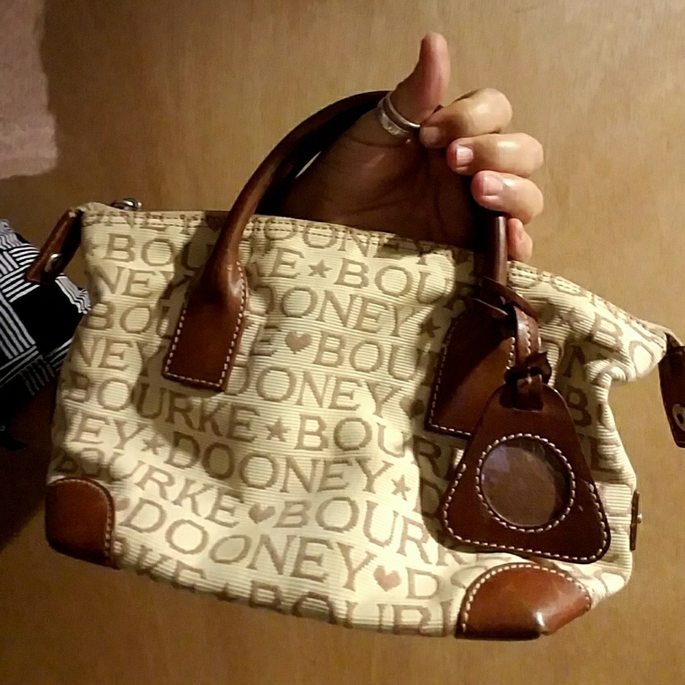 Cream Dooney & Bourke purse with brown lettering