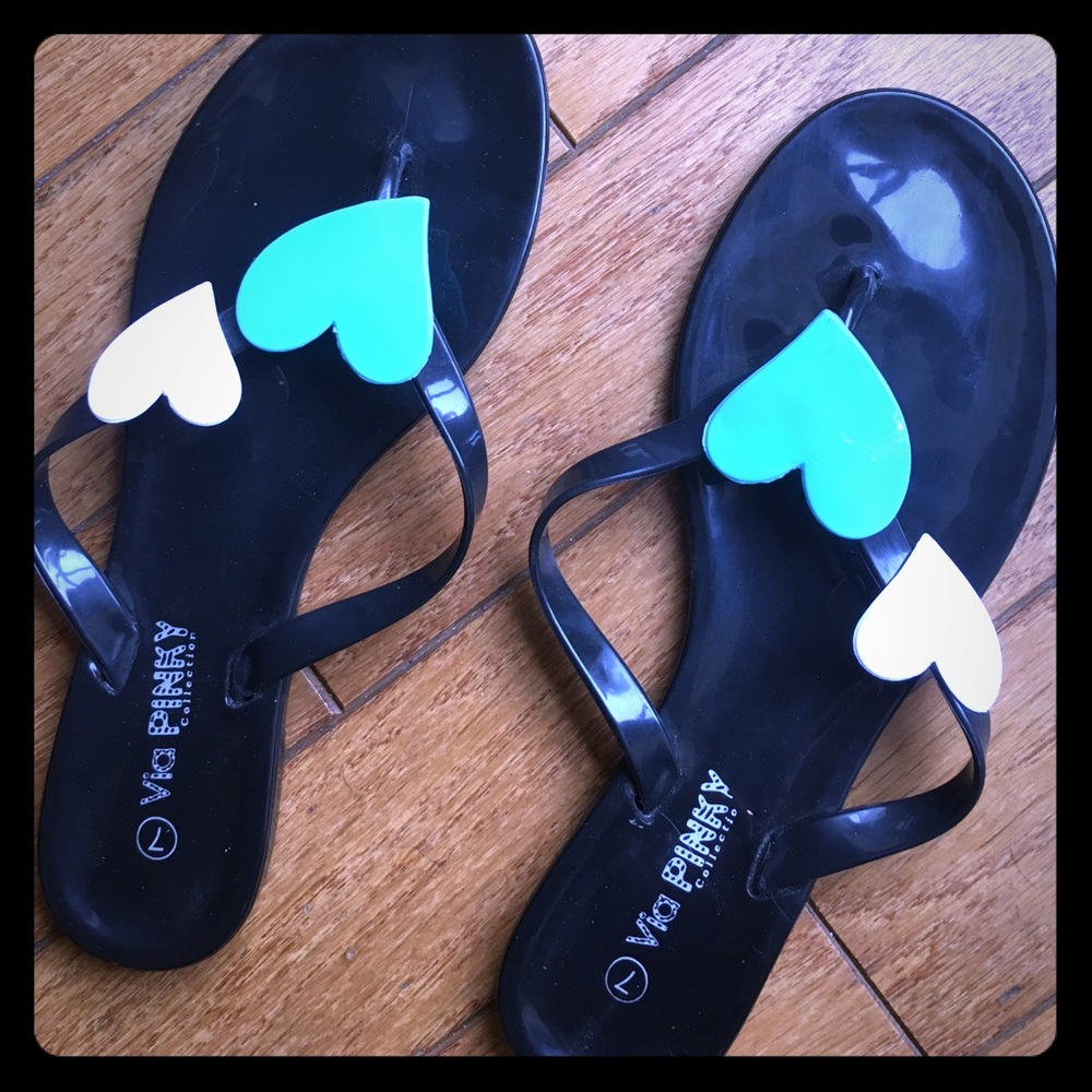 Black flip flops with heart design.