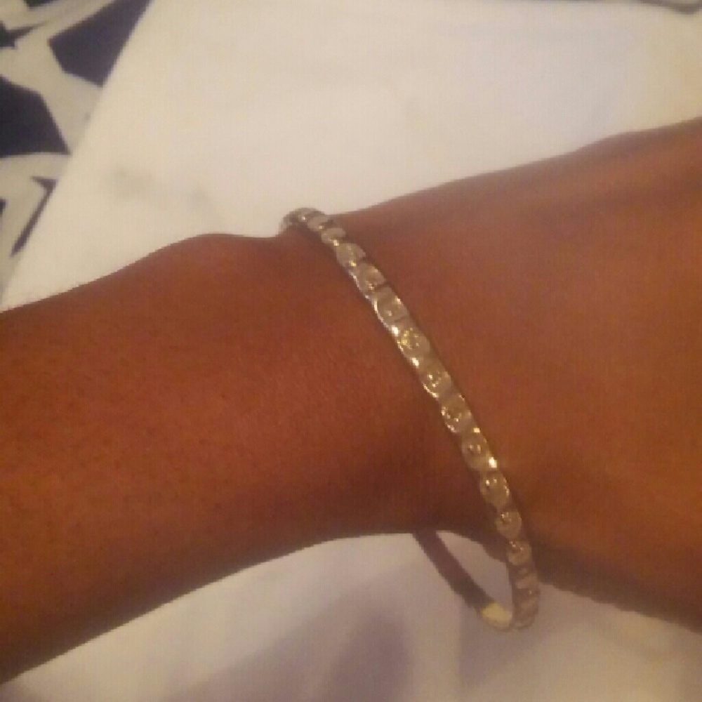 Gold tone metal bangle