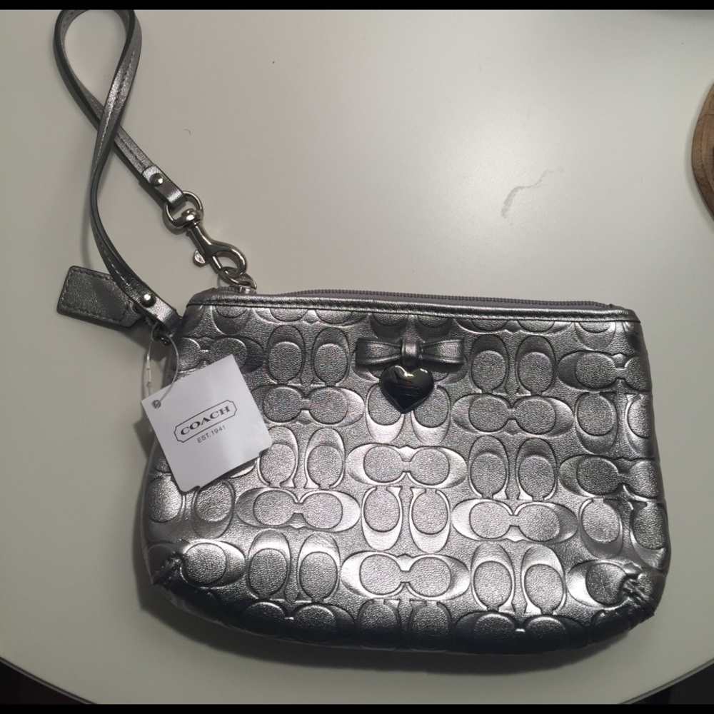 Coach wristlet. Never used. Silver heart charm.