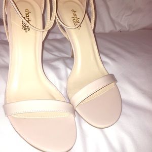 Nude ankle strap heels.