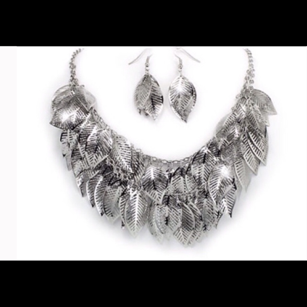 Dozens of silver leaves cascade from designer ne..
