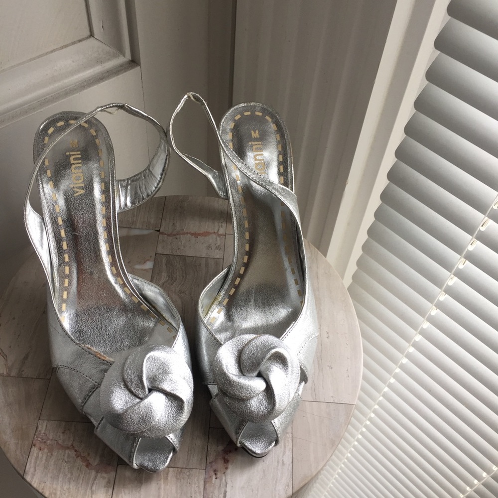 Sling back silver shoes.