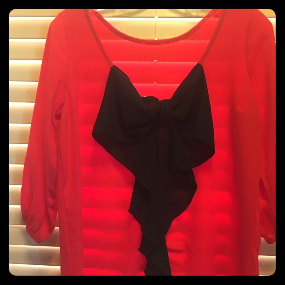 Boutique style red blouse with black bow on back