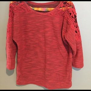 Orange top with cut out shoulders.