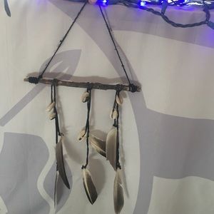 Handmade dream catcher with shells and feathers