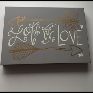 Grey wooden lots of love sign
