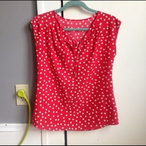 Red sleeveless top with white polka dots