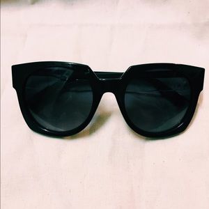 Alexander McQueen black sunglasses.