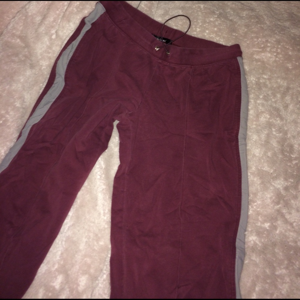 Maroon sweatpants with gray stripe down the side