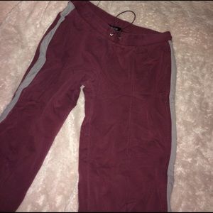 Maroon sweatpants with gray stripe down the side