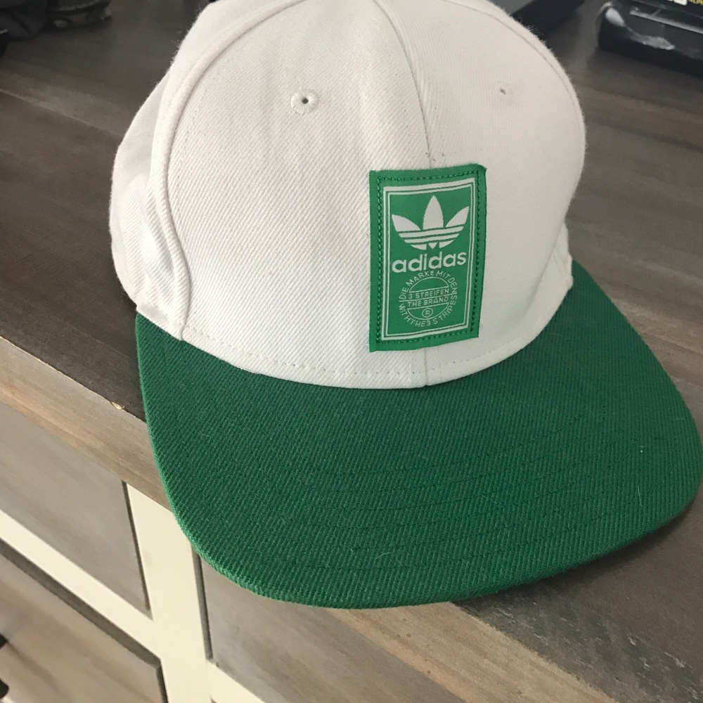 White and green adidas hat.